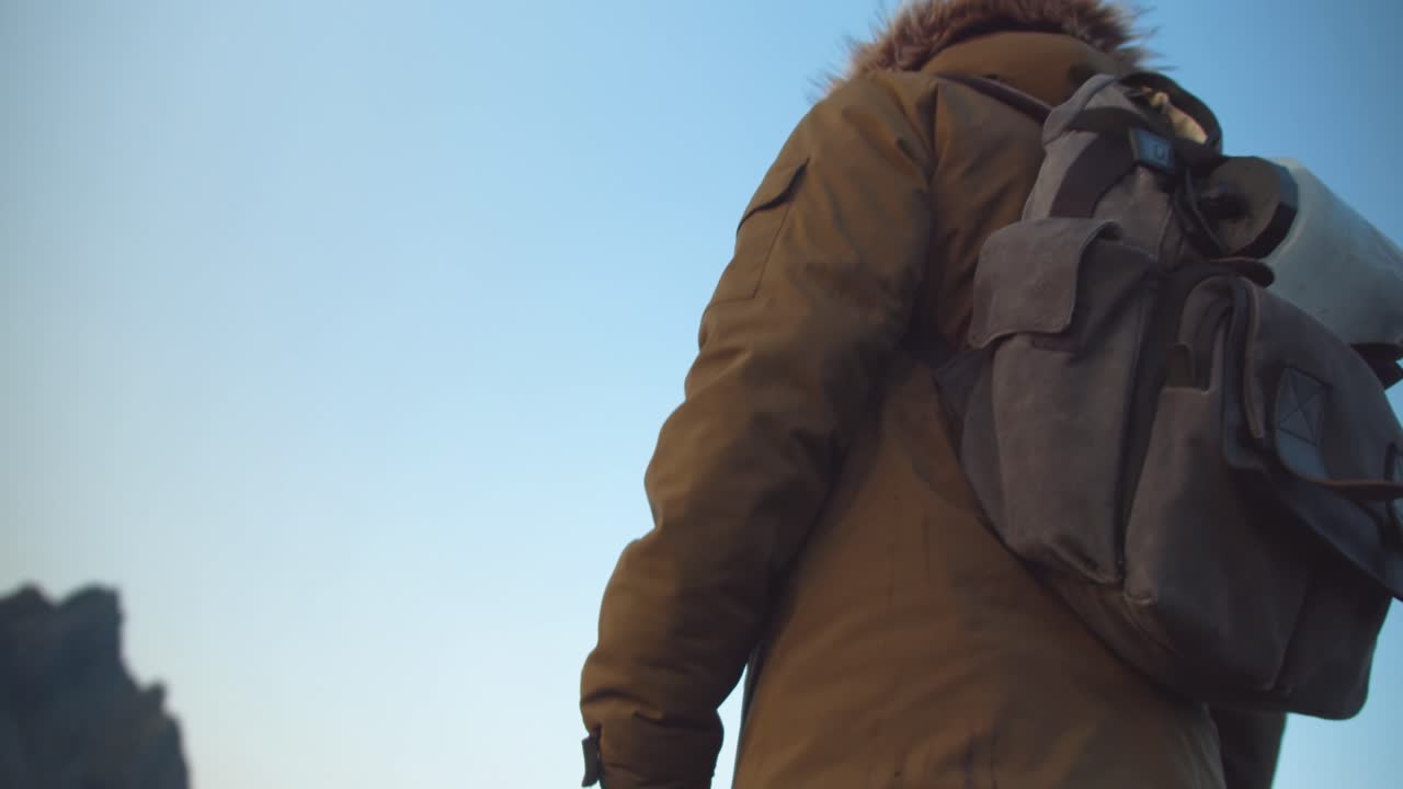Person hiking with a backpack in a mountainous landscape