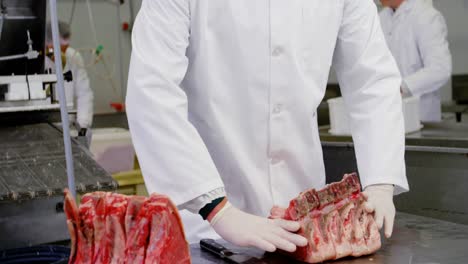 butcher arranging chopped red meat