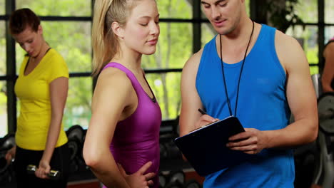 male trainer helping blonde woman with performance