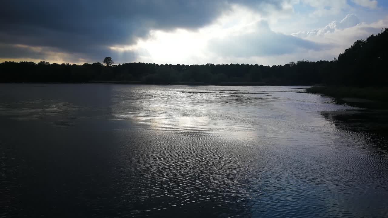 A rainy, overcast look at the calm lake at Coate Water, Swindon