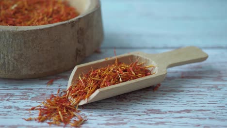 saffron spice in wooden bowl and scoop