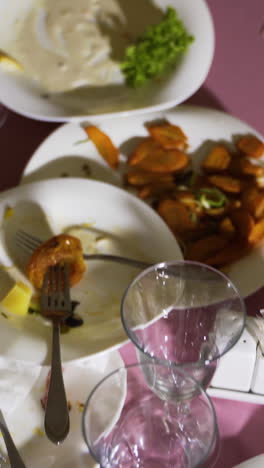 a lot of dirty dishes with leftover food. the concept of the restaurant business. vertical video