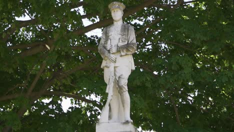 statue of a solider in a forest