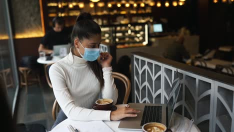 woman working on laptop in a coffee shop