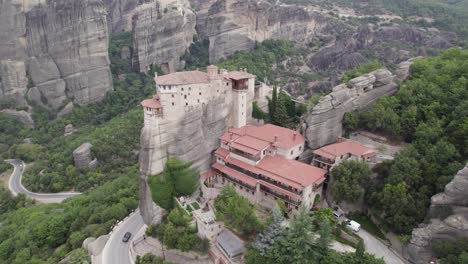Breathtaking-aerial-of-Rousanou-monastery-on-top-of-rocky-precipice,-Meteora