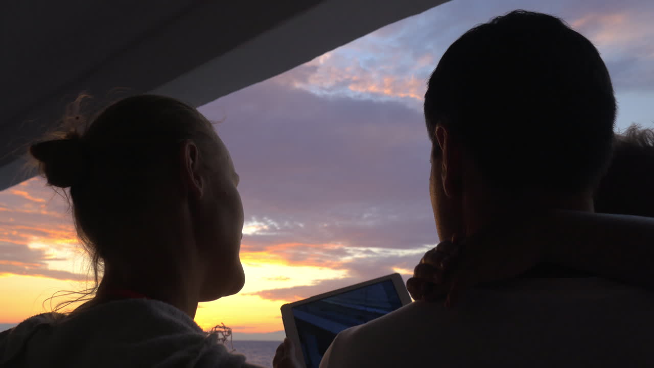 At sunset family photographed on tablet in city Perea Greece