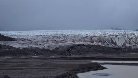 svinafellsjokull glacier, iceland, huge ice mass under dark clouds, panorama