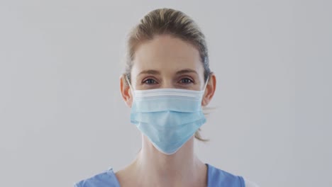 Female-health-worker-wearing-face-mask-at-home
