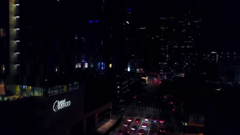 aerial descending shot of urban city street at night. 4k