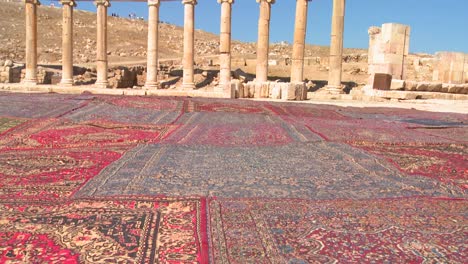 pan up from arab carpets to the roman ruins of jerash in northern jordan