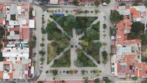 Top-down-drone-shot-of-a-park-surrounded-by-buildings-of-cafayate-town-of-salta-in-Argentina-south-america