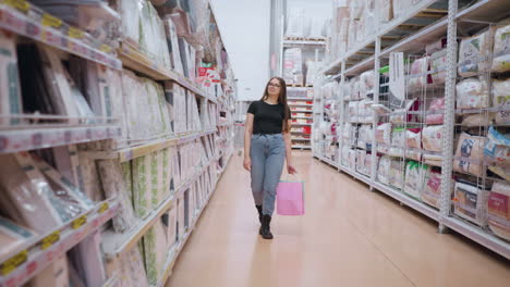 girl walking through supermarket aisle holding shopping bag, looking at goods on shelf before turning attention to left, background filled with stocked shelves and product displays in retail setting