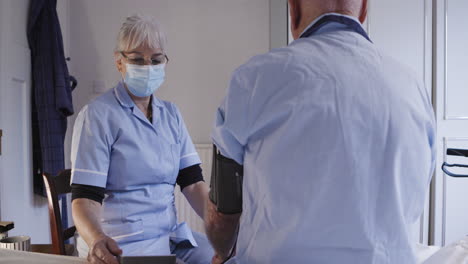 nurse taking patient's blood pressure
