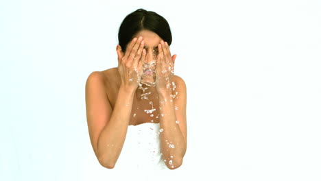 woman washing her face