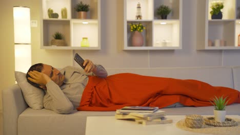 man looking at phone in depressed mood.