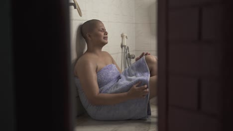 sick bald indian girl breaks down in bathroom and is very upset and cries