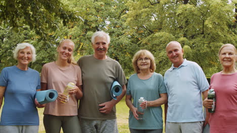 portrait of sporty senior people and female trainer in park