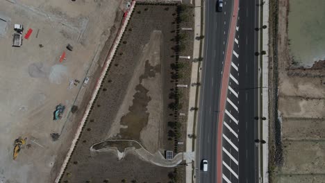 Aerial-view-of-a-large-construction-site-next-to-a-newly-built-main-road