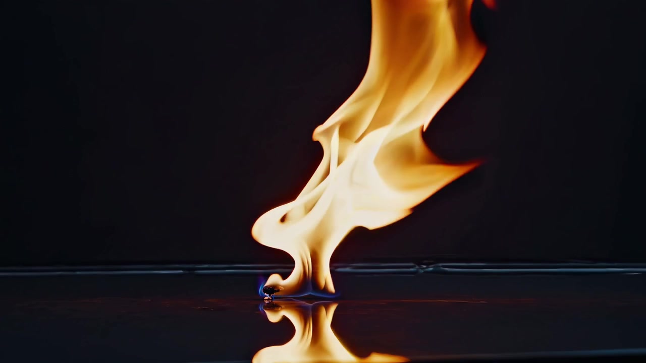 Dynamic Orange Flame Burning and Reflecting on a Black Surface
