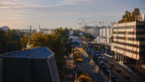 flock of doves gather in shade ontop of building in vienna as traffic rushes by at golden hour