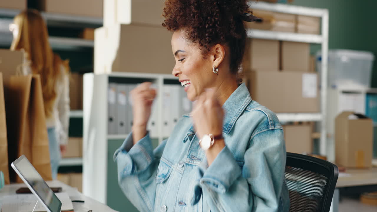 Excited woman celebrating business success in an office