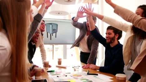 young business group cheering after business meeting