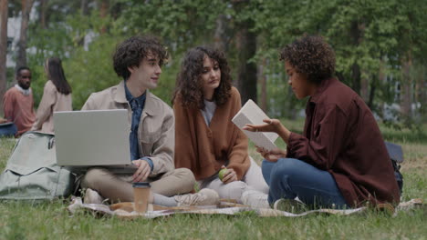 students having a picnic and discussing