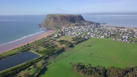 aerial flight over stanley with huge rock in background in tasmania, australia