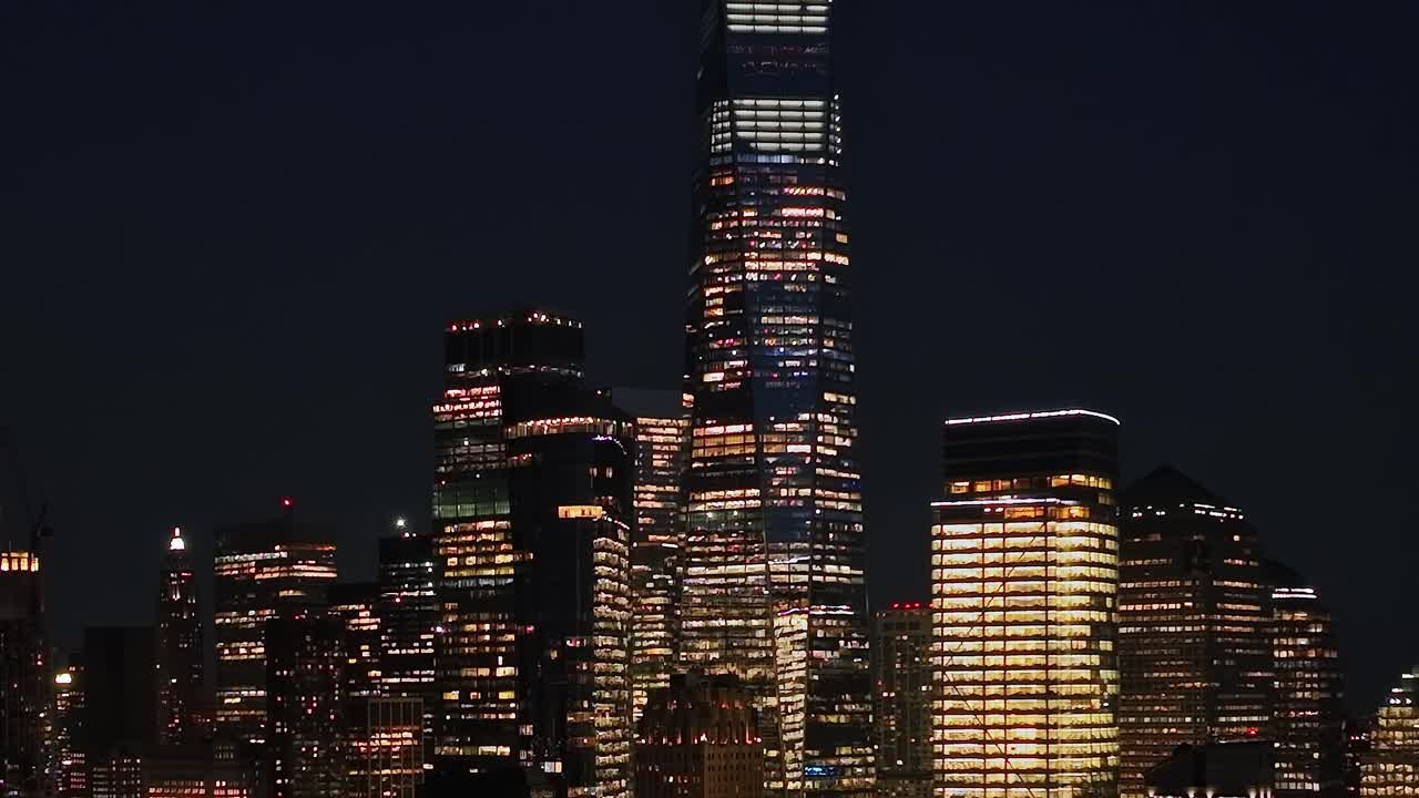 Aerial view of New York City skyline at night with lights glowing