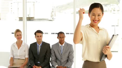 Businesswoman-giving-thumbs-to-camera