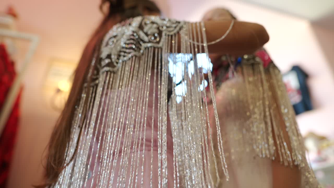 Women wearing embellished capes