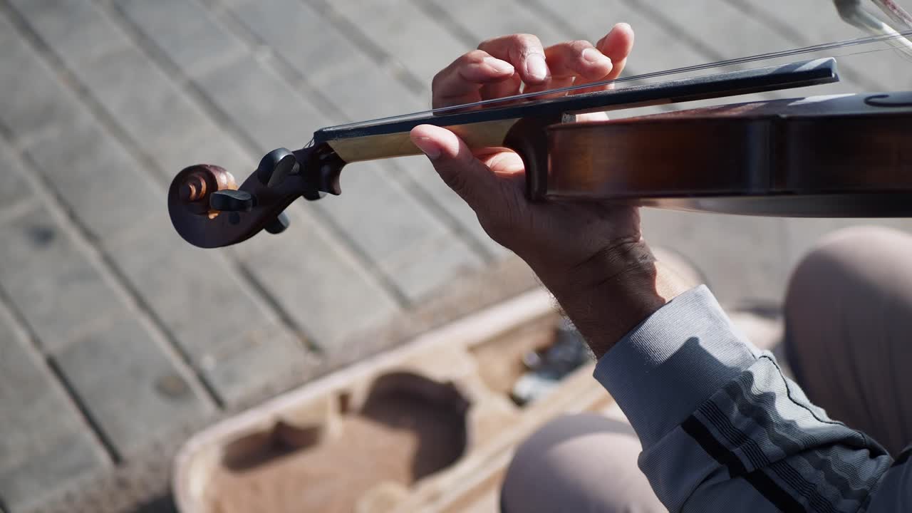 A Man Plays The Violin On The Street