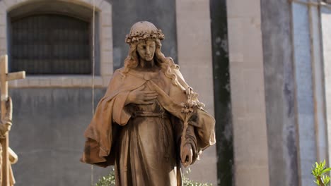 panning right on a statue in front of basilica cattedrale di sant'agata in catania, sicily, during golden hour, capturing intricate details