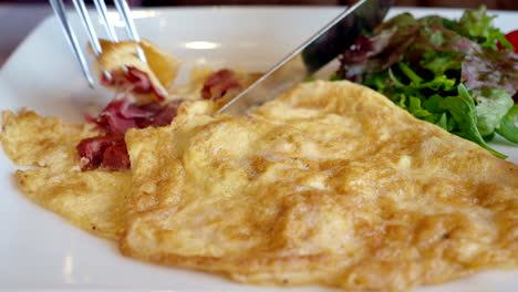 a close-up of a delicious omelette with salad