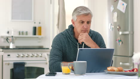 laptop, breakfast and kitchen with a mature man