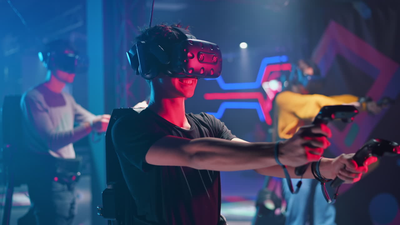 A joyful, interested boy is playing on VR treadmill with helmet, controllers and a backpack. Other people playing nearby