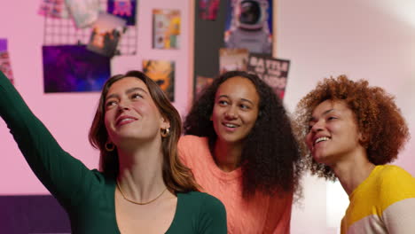 three friends taking a selfie in a colorful room