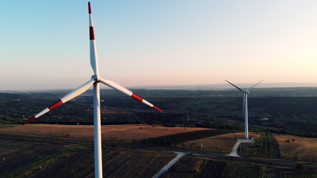 A traditional rural scene featuring a man riding a wooden horse drawn cart along a quiet road lined with old houses and trees