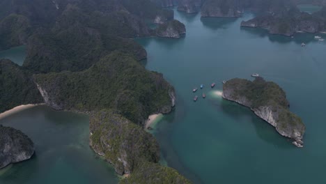 drone shot of beautiful tropical islands in bright blue water in cat ba and halong bay in northern vietnam