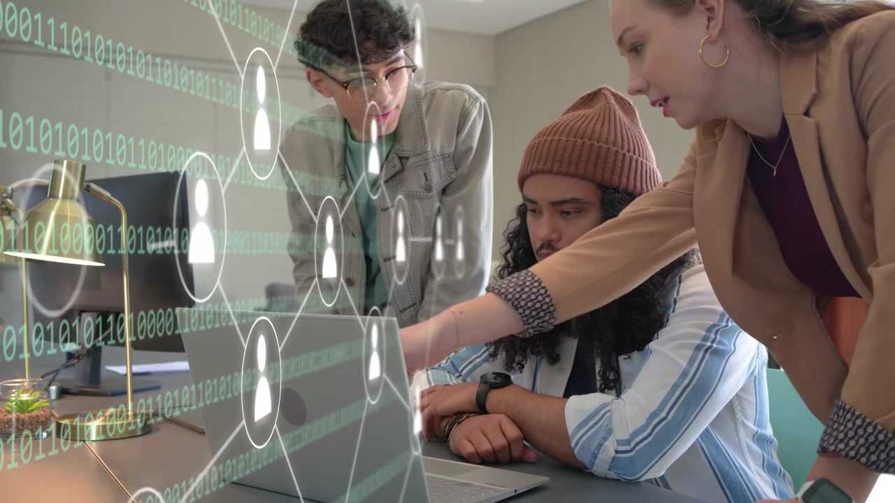 Developer tapping laptop and causing network overlay highlighting nodes while team reviewing tech
