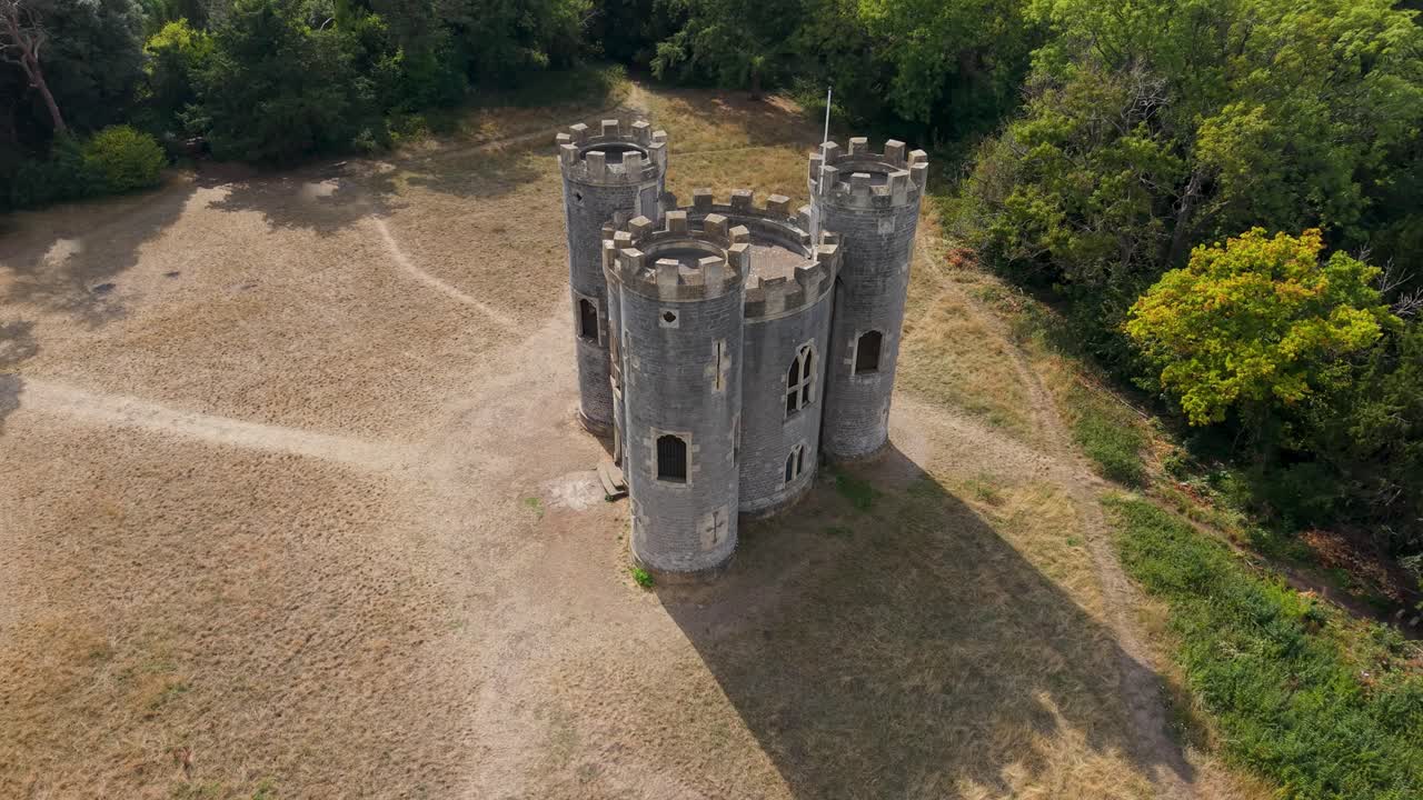 Aerial drone rotation at Blaise Castle, Bristol. Starting level with the turrets, the drone moves upward and right, revealing a sweeping shadow extending beside the castle for a striking visual effect