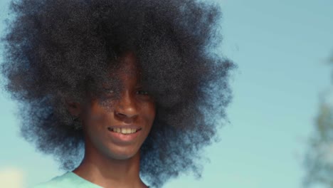 african american adolescent boy with huge afro looking into the camera