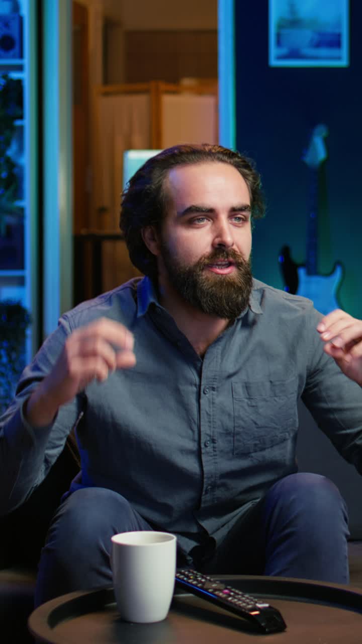 Vertical video Excited fan watching live sports event on TV, rooting for favorite team