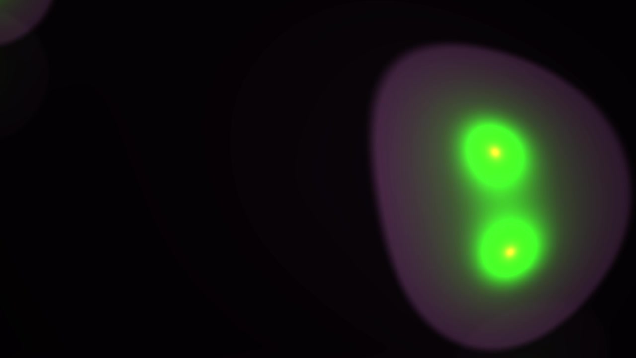 Dynamic Green and Purple Optical Flares on Dark Background