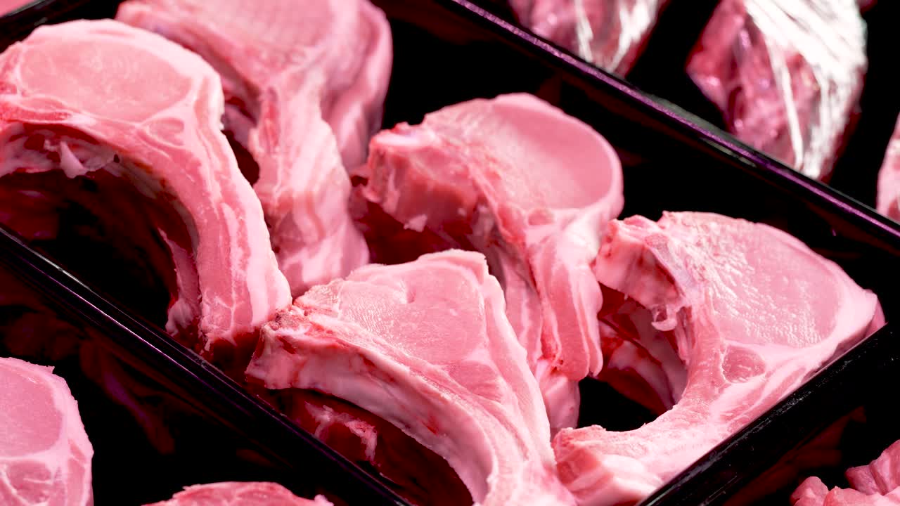 A vibrant fresh market showcases beautifully arranged pork chops, drawing attention from shoppers and culinary enthusiasts eager for quality meat. The ambiance buzzes with excitement