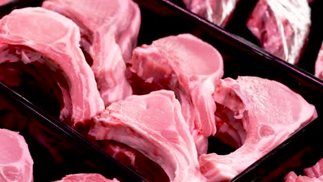 a vibrant fresh market showcases beautifully arranged pork chops, drawing attention from shoppers and culinary enthusiasts eager for quality meat. the ambiance buzzes with excitement