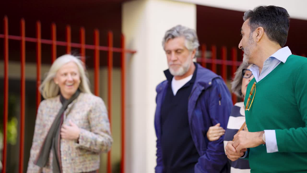 A group of elderly people walking down the street