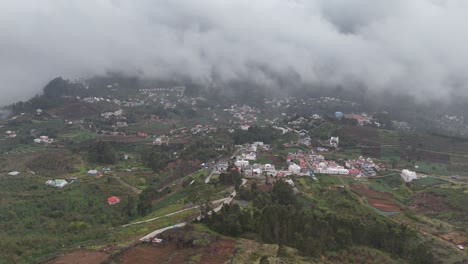aerial view of mist rolling over kodaikanal’s hillside town during early morning
