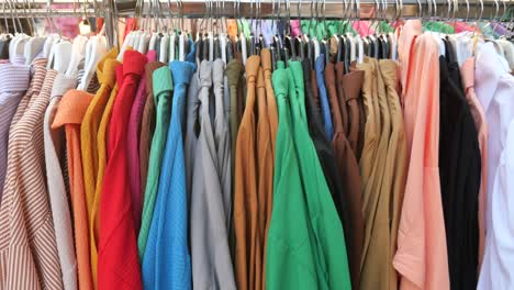 colorful shirts on hangers in a clothing store