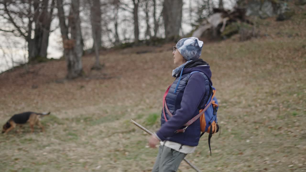 Senior woman hiking in autumn forest